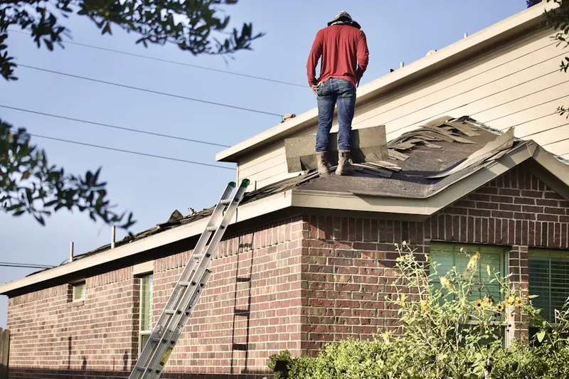 Professional roofer working on a residential roof in Egypt